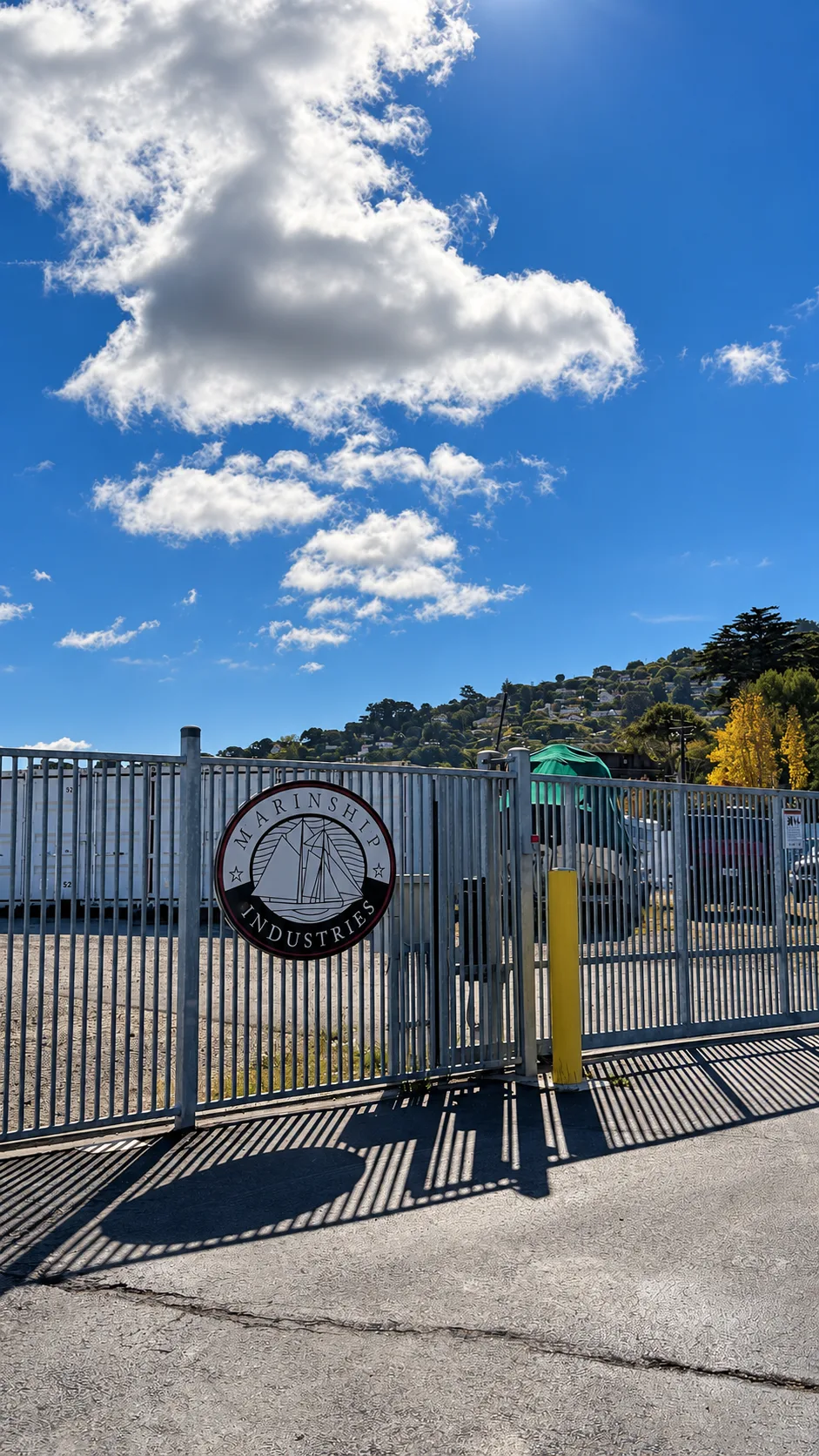 Security gate with the Marinship Industries sign at the Sausalito storage yard